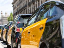 A number of taxis lined up at a taxi rank